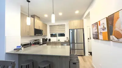a kitchen with a large island in the middle at 3BR Family House in NE Edmonton in Edmonton