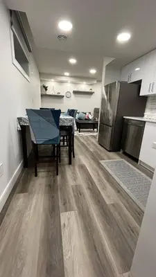 a kitchen with a ping pong table in a room at Cozy 2 bedroom suite in Edmonton
