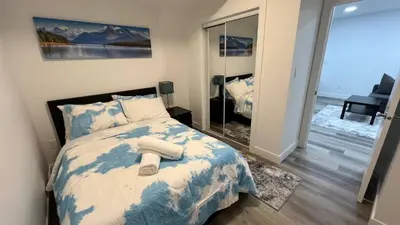 a bedroom with a bed with two towels on it at Cozy 2 bedroom suite in Edmonton
