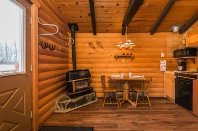 a kitchen with a table and a stove in a room at The Wolf Cabin - Bear Creek Cabins in Winfield