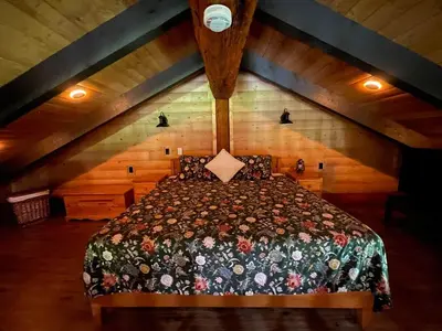 a bedroom with a large bed in an attic at The Yellowstone cabin - part of Bear Creek Cabins in Winfield