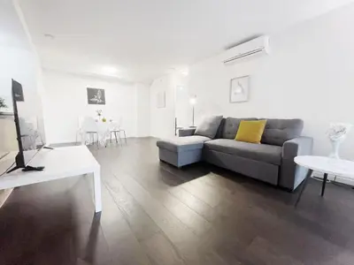 a living room with a couch and a table at Bright & Cozy 2B2B near transit in Richmond in Richmond