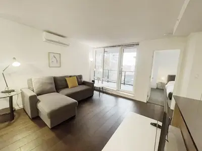a living room with a couch and a table at Bright & Cozy 2B2B near transit in Richmond in Richmond