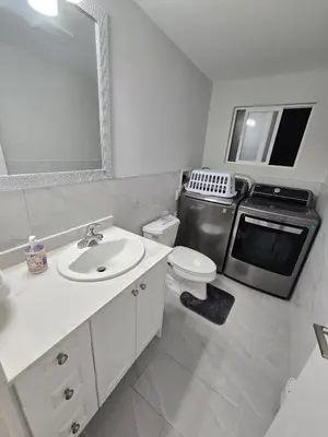 a white bathroom with a sink and a microwave at 3 BR Lux home with AC in a central location in Delta