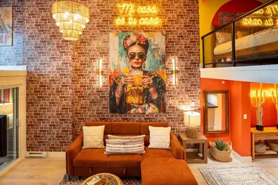 a living room with a couch and a painting of a woman at Casa DT Vancouver - Mexican Theme in Vancouver