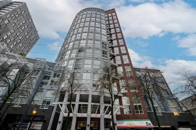 a tall white building with trees in front of it at Casa DT Vancouver - Mexican Theme in Vancouver