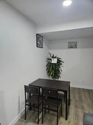 a dining room with a table and chairs and a plant at Your home away from home comfortable, and calm, in Edmonton
