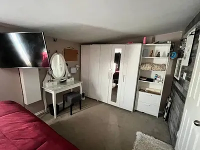 a bedroom with a bed and a desk and a mirror at Rustic suite in small town Alberta Canada in Penhold
