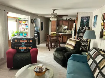 a living room with two couches and a table at Rustic suite in small town Alberta Canada in Penhold