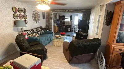 a living room with a couch and a tv at Rustic suite in small town Alberta Canada in Penhold