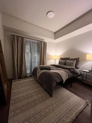 a bedroom with a large bed and a window at New Condo with Pool and Hot Tub Sleeps 9 in Canmore