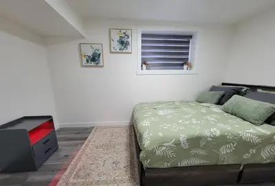 a bedroom with a bed and a window at New 2BR Home - Family Friendly - Near YYC Airport & Downtown - 4412 - DN in Calgary