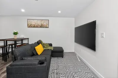 a living room with a couch and a flat screen tv at New 2BR Home - Family Friendly - Near YYC Airport & Downtown - 4412 - DN in Calgary