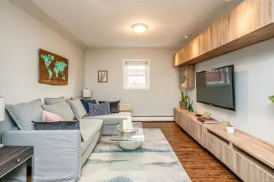 a living room with a couch and a tv at Spacious One Bedroom Queen Bed Inner City Stay in Calgary