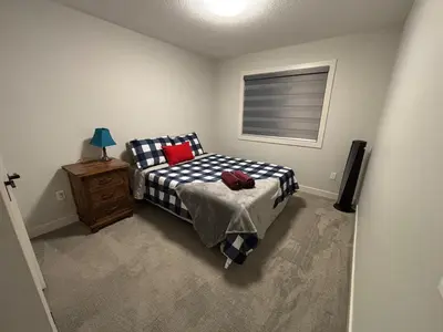 a bedroom with a bed and a television in it at Luxury 3bedroom House with Kingsize Master bedroom in Airdrie