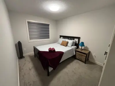 a bedroom with a bed with a red bow on it at Luxury 3bedroom House with Kingsize Master bedroom in Airdrie