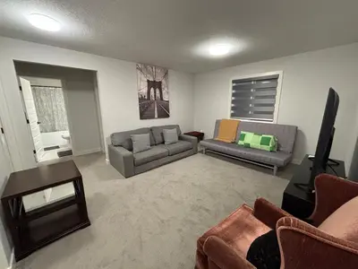 a living room with two couches and a tv at Luxury 3bedroom House with Kingsize Master bedroom in Airdrie