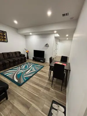a living room with a couch and a table at Fowler Road Cozy Lower Suite in Airdrie