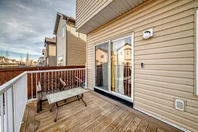 a balcony with a bench on a wooden deck at Cozy Vacation Home in Calgary