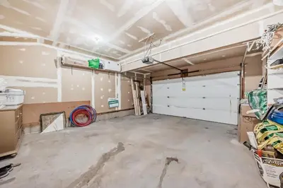 a garage with two white garage doors at Cozy Vacation Home in Calgary
