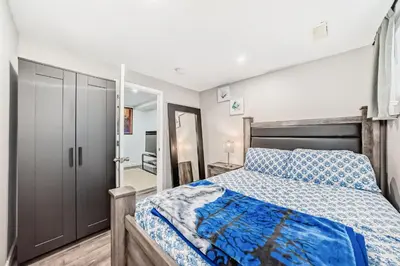 a bedroom with a bed and a closet at Cozy Vacation Home in Calgary