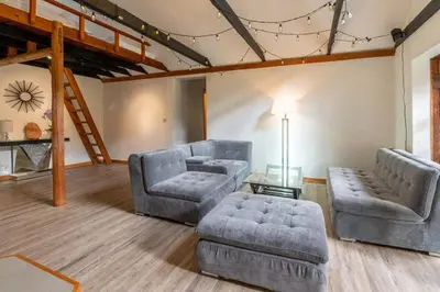 a living room with two chairs and a couch and a table at Picturesque and Comfy Escape with Waterfall View in Garden Bay