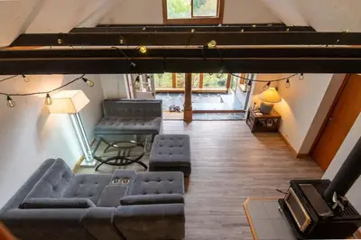 an overhead view of a living room with couches and a piano at Picturesque and Comfy Escape with Waterfall View in Garden Bay