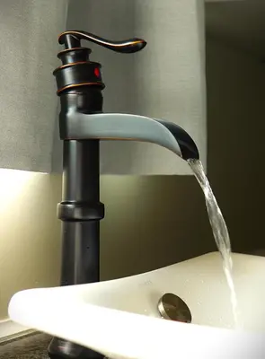 a sink with water coming out of a faucet at Creekside Haven on a Sleddog Farm in Dovercourt