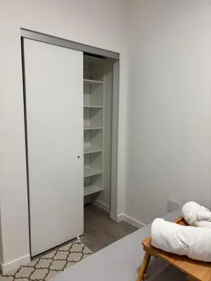 a room with a closet with a sliding door at Cozy 1 bed and 1bath suit in Surrey