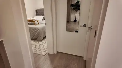 an open door to a bedroom with a bed at Cozy 1 bed and 1bath suit in Surrey