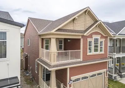 a house with a porch and a balcony at A beautiful home in Airdrie in Airdrie
