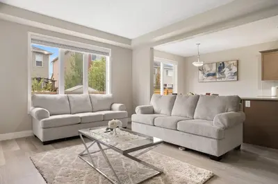 a living room with two couches and a table at A beautiful home in Airdrie in Airdrie