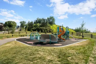 a playground with a slide in a park at Bright and Open Coziness. 10 minutes to Stampede in Calgary