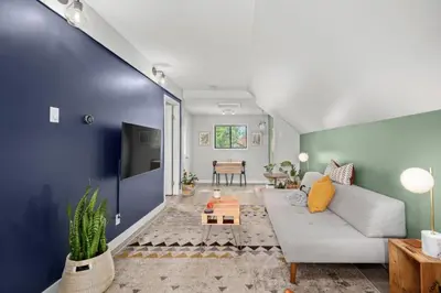 a living room with a couch and a table at Mid Century Zen Suite. 1 BR. Near DT, C-train. in Calgary