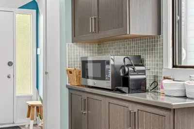 a kitchen with a counter top with a microwave at Funky 1 BR Century Home-Near DT, C-train in Calgary
