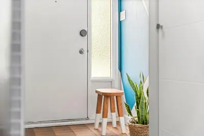 a stool sitting in front of a door at Funky 1 BR Century Home-Near DT, C-train in Calgary