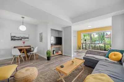 a living room with a couch and a table at Funky 1 BR Century Home-Near DT, C-train in Calgary