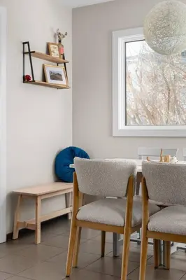 a dining room with a table and chairs and a window at Bright and Welcoming Mount Pleasant Home, near DT in Calgary