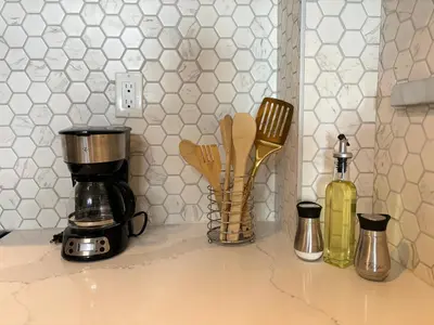 a counter top with a coffee maker and a blender at Cool and Cozy 17th Ave Nest in Calgary