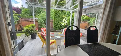 a screened in porch with a table and chairs at Premium stay in Metro Vancouver-World Cup ready in Coquitlam