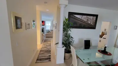 a hallway with a glass table and a living room at Premium stay in Metro Vancouver-World Cup ready in Coquitlam