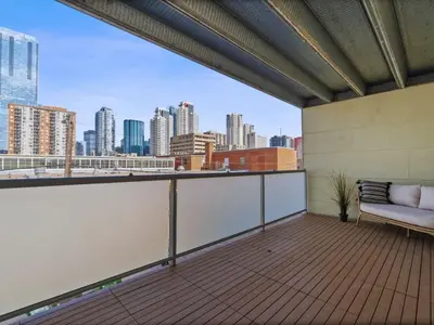 a balcony with a couch and a view of the city at Luxury 2BR 2BA Loft Ice District W Heated Parking in Edmonton