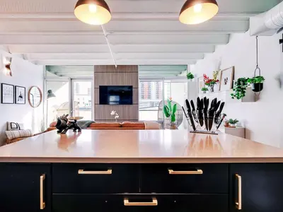 a kitchen with a large island in a living room at Luxury 2BR 2BA Loft Ice District W Heated Parking in Edmonton