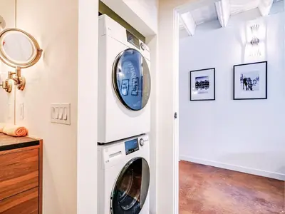 a laundry room with a washer and dryer at Luxury 2BR 2BA Loft Ice District W Heated Parking in Edmonton