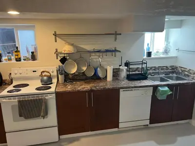 a kitchen with a white stove and a sink at Poolside Shared Suite - Private Queen Room with Heated Pool in Victoria
