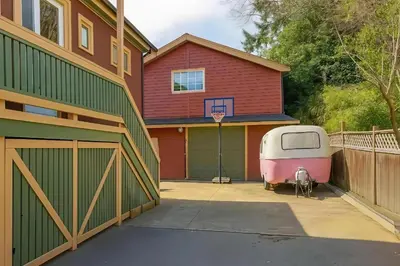 a garage with a trailer parked in front of a house at Poolside Shared Suite - Private Queen Room with Heated Pool in Victoria