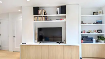 a entertainment center with a tv in a living room at Modern 3-Bdrm Home & Parking - Cambie Village-VGH in Vancouver