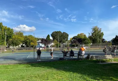 a group of people standing on a tennis court at Modern 3-Bdrm Home & Parking - Cambie Village-VGH in Vancouver