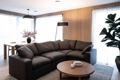 a living room with a brown couch and a table at Luna Ridge - Thoughtfully Designed 3-Bedroom Condo in Revelstoke