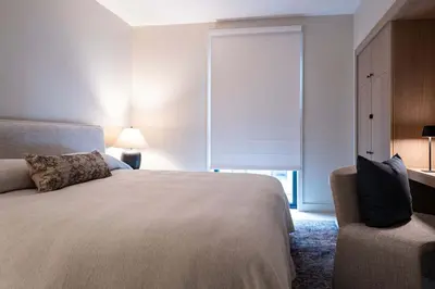 a bedroom with a large bed and a window at Luna Ridge - Thoughtfully Designed 3-Bedroom Condo in Revelstoke